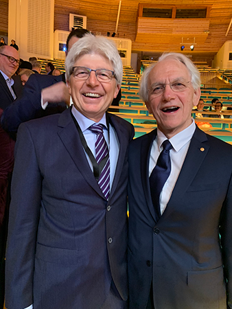 Juhasz, UCI professor of biomedical engineering and ophthalmology (left), and Nobel winner Mourou are pictured in Stockholm before the Nobel Prize ceremony, which Juhasz called “magnificent.”