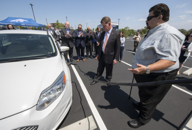 Ronald Fleming, right, executive director of UCI Transportation & Distribution Services, helps U.S. Secretary of Labor Marty Walsh connect an electric car with a campus charging station, with Chancellor Howard Gillman, UC Regent John A. Pérez, UCI Vice Chancellor for Research Pramod Khargonekar, U.S. Rep. Mike Levin and Irvine Mayor Farrah Khan looking on. Steve Zylius / UCI