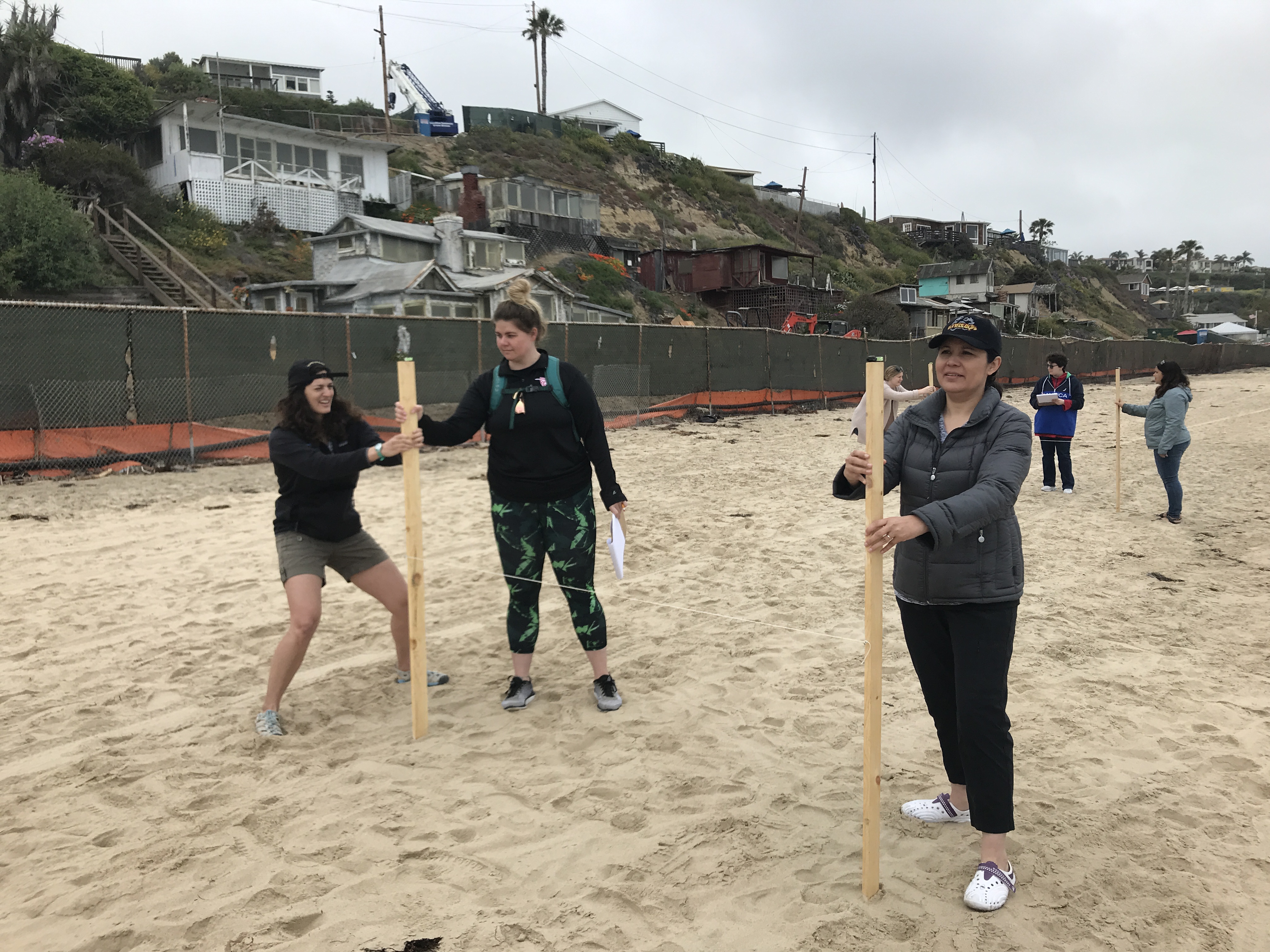 UCI students measure beach dynamics with an emery board