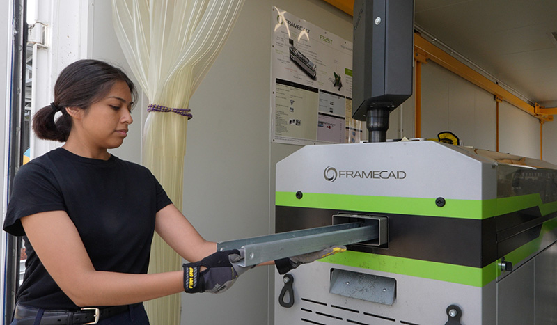 An OCC architecture student prints steel framing with the FrameCAD machine at OCC (Photo: Natalie Tso/UCI)