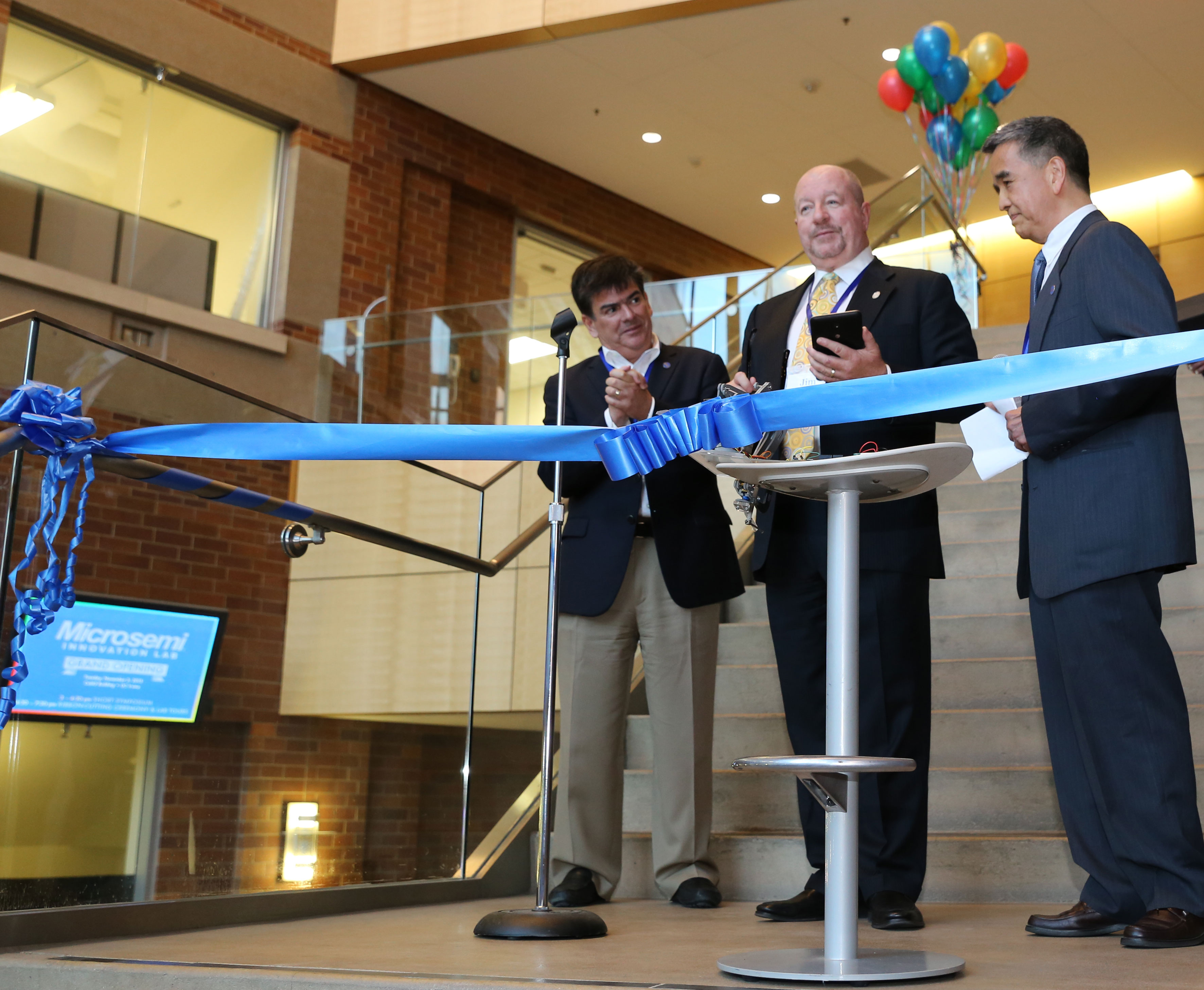 From left: UCI Provost Enrique Lavernia, Microsemi CEO Jim Peterson and Calit2 Director G.P. Li prepare to cut the ribbon officially opening the Microsemi Innovation Lab at Calit2