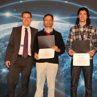 Associate Professor Syed Jafar (center) and graduate student Arash Gholamidavoodi (right) accept a Best Paper Award at IEEE GLOBECOM 2014 
