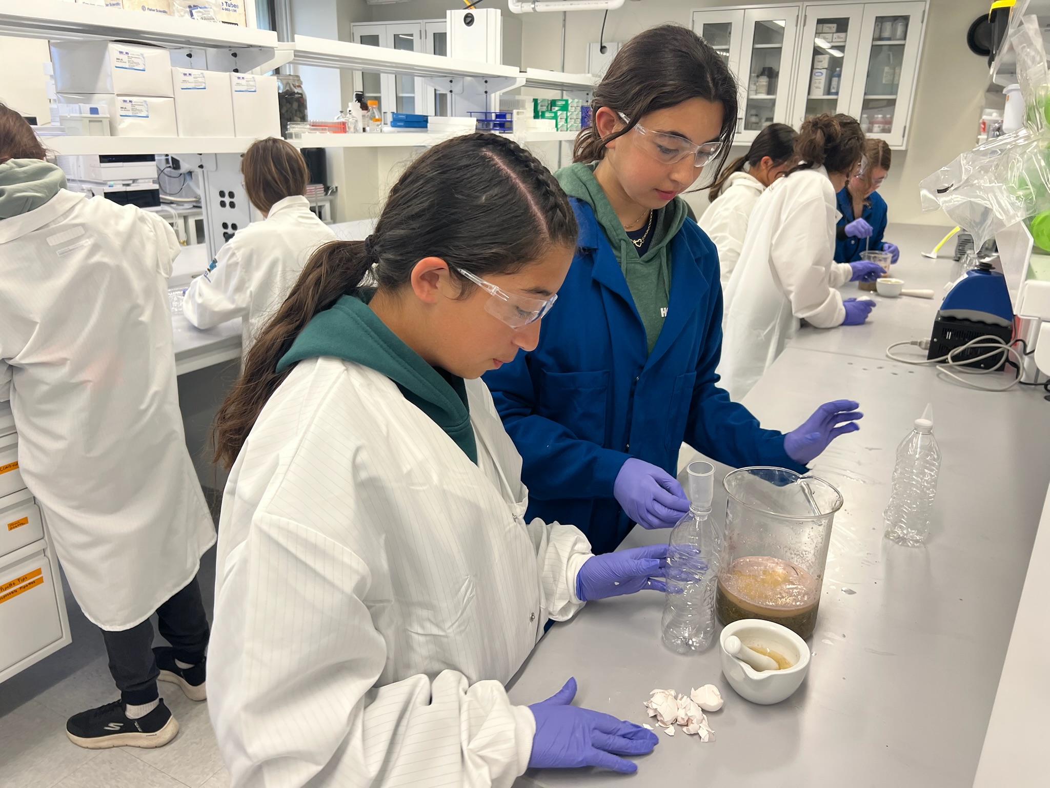 Two middle school students work together on the experiment in Hobb’s laboratory. 