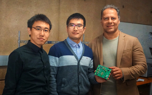 Graduate students Zisong Wang and Huan Wang (from left), along with their adviser, Heydari, display a testing board containing their novel receiver chip. The three say the chip provides all the benefits of N-Path filtering while mitigating the problem of spurious re-radiation.