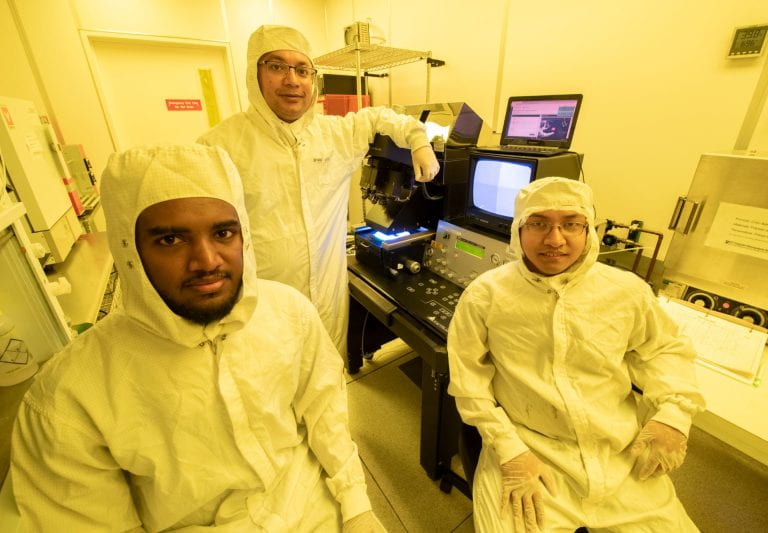 Achamyeleh, Al Faruque and Barua (from left) conducted part of their research into a potential threat to negative pressure facilities in an actual clean room designed to prevent external exposure to dangerous microbes. Steve Zylius / UCI