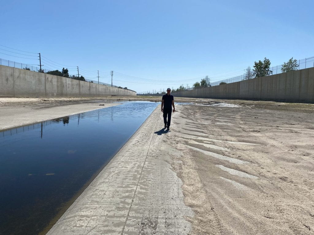 “The impacts of a severe flood would not be evenly distributed across Angelinos. Disadvantaged communities are disproportionately affected, and they’re less well protected,” says Brett Sanders, UCI professor of civil and environmental engineering, here walking in the Santa Ana River channel. Jo Kwon / Spectrum News