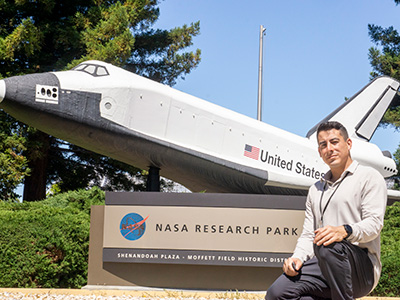 Cody Gonzalez in front of NASA sign