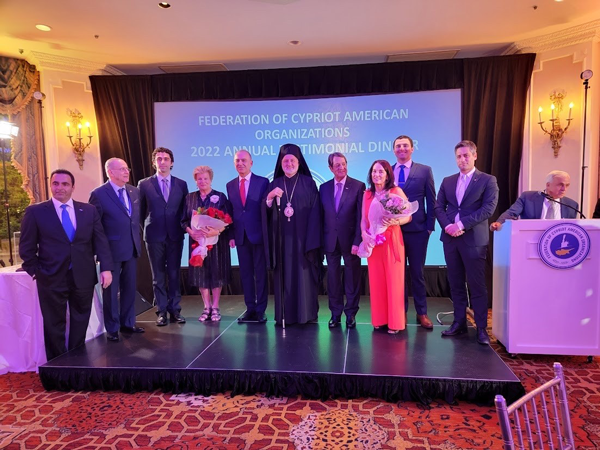 Kyriacos A. Athanasiou stands on stage at the FCAO’s annual Testimonial Dinner in New York with distinguished guests, including President of Cyprus Nicos Anastasiades and first lady Andri Anastasiades.