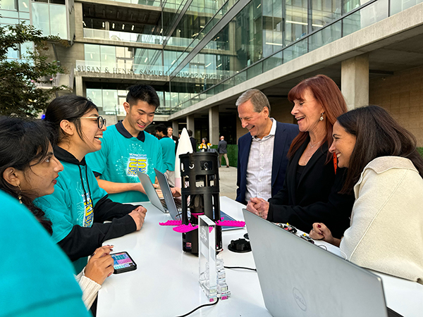 The UCI CanSat team shares their soda-can sized satellite, a second place winner among U.S. teams, with the Samuelis. 