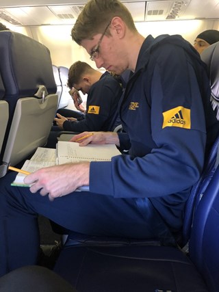 Tommy studying on plane ride home from UC Davis