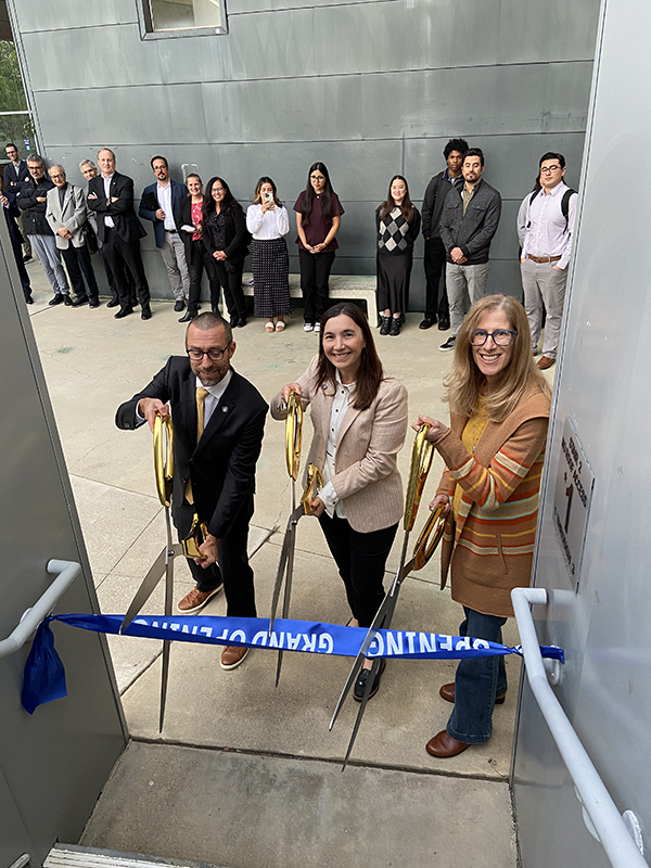 From left, UCI Engineering Dean Magnus Egerstedt, OAI Executive Director Analia Rao and UCI Foundation trustee Stacey Nicholas cut the ribbon at the stairway that leads to the renovated Stacey Nicholas Office of Outreach, Access and Inclusion.