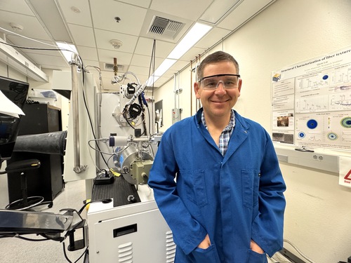 Alon Gorodetsky in front of the electron beam evaporation system at his UCI lab.