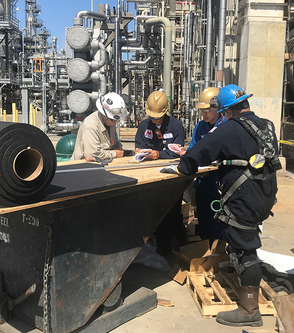 Christopher (second from right) evaluating work safety at Marathon Refinery Corporation