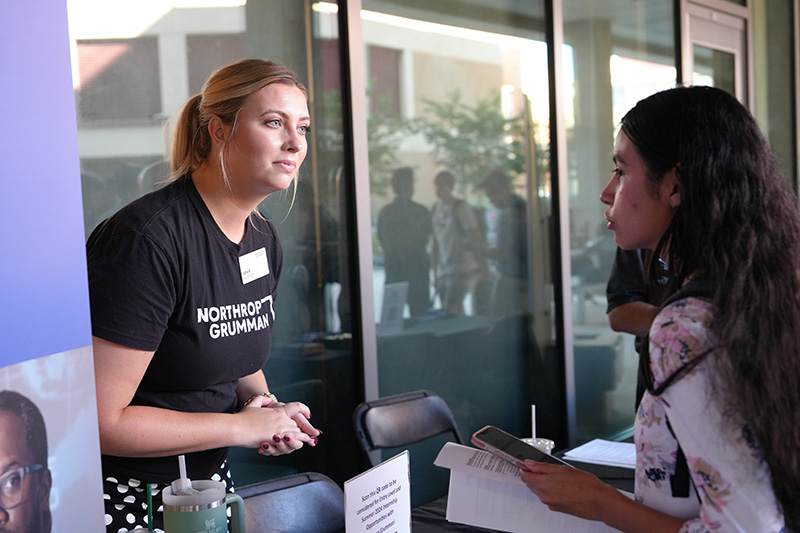 An engineering student networks at a UCI-sponsored industry event