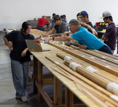 Project manager and mechanical engineering student Stuti Patel reviews plans with Experimental Aircraft Association member Rhon Williams. Photo: Flying Leathernecks Heritage Foundation
