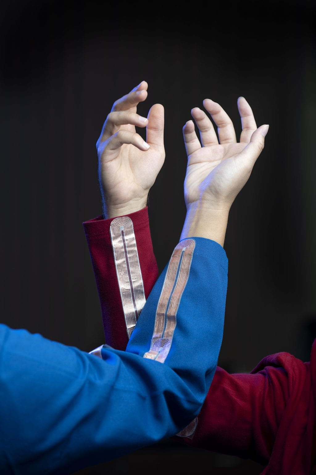 An innovative, new high-tech fabric created by engineers at UCI enables wearers to communicate with others, wirelessly charge devices and pass through security gates with the wave of an arm. Steve Zylius / UCI