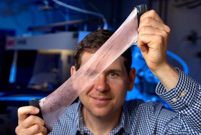 Alon Gorodetsky shows off the adaptive heat-managing composite material his lab developed that is nicknamed after its inspiration: squid skin. Steve Zylius / UCI