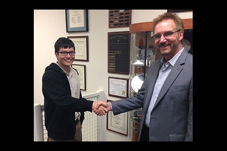 Dat Huynh (left) is congratulated by MAE Chair Ken Mease
