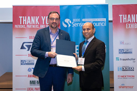 Andrei Shkel (left) receives the John Vig Meritorious Service Award from Ravinder Dahiya, president of the IEEE Sensors Council.