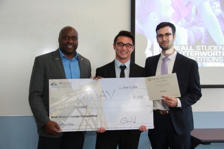 FWMAV team members accept their first-place check for $10,000. From left: Engineering Dean Gregory Washington, Patrick Zhu and Nathan Cabezut (not pictured, team member Bao Pham).