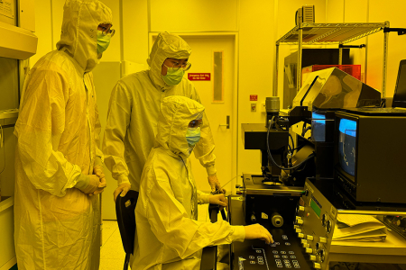 Students work on an aligner for photolithography in UCI’s clean room.