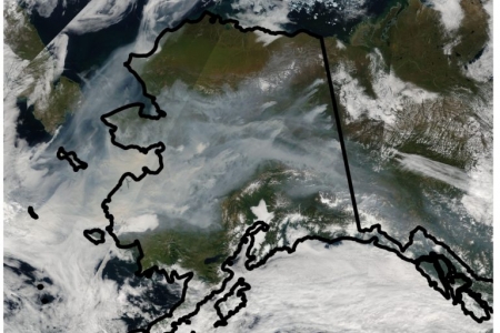 A satellite image of Alaska captured in August 2005 shows the extent of smoke coverage from wildfires in the state’s boreal forests. The blazes are likely to become large in exceptionally hot and dry conditions and when there’s a high percentage of black spruce trees in the affected areas – key factors in a new predictive model developed by UCI scientists. NASA