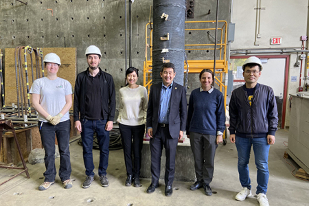 From left, Kathryn Jones, Amadeu Malats Domenech, Mo Li, Dave Min, Iryna Zenyuk and Wei Geng stand in front of a robotically additively manufactured concrete column being tested for structural performance.