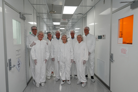 UCI Foundation trustees, from left,  John Carrington, Mary Carrington, Kate Klimow, Dick Ackerman, Linda Ackerman, Gary Singer, Dulcie Kugelman and Bob Romney suit up for a tour of the INRF clean rooms. 