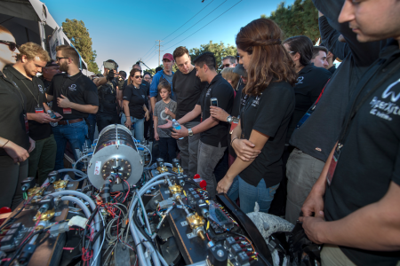 At the Hyperloop Pod Competition, UCI senior Nathan Sharifrazi (right, with water bottle) talks about the HyperXite pod with Elon Musk, the CEO of SpaceX and Tesla and visionary behind the Hyperloop concept. Steve Zylius / UCI