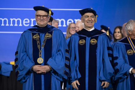 New York Tech President Hank Foley (left) stands with honorary degree recipient Kyriacos A. Athanasiou, UC Irvine Distinguished Professor of biomedical engineering, who delivered the commencement address at the NYIT graduation ceremony on May 19. 