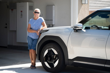 Woman standing next to car and garage.