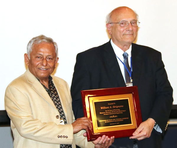 Texas Tech University’s Fazle Hussain (left) presents Distinguished Professor William Sirignano  with a plaque at a symposium, held last fall, celebrating Sirignano’s many years of scholarly contributions.