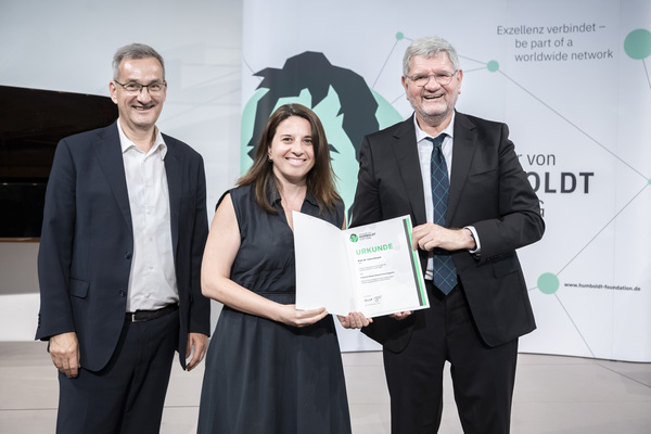 Iryna Zenyuk (center) being presented with the Friedrich Wilhelm Bessel Research Award