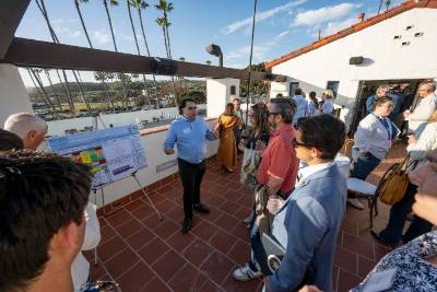 Jacob Samson (center), a graduate student in mechanical and aerospace engineering, leads a presentation about UC Irvine Climate Collaboration research to improve the resiliency of California’s coastline at a 2025 event in San Clemente. The UCICC operates on dual principles of interdisciplinary collaboration and engagement with external partners, including government agencies, community groups and businesses. Steve Zylius / UC Irvine