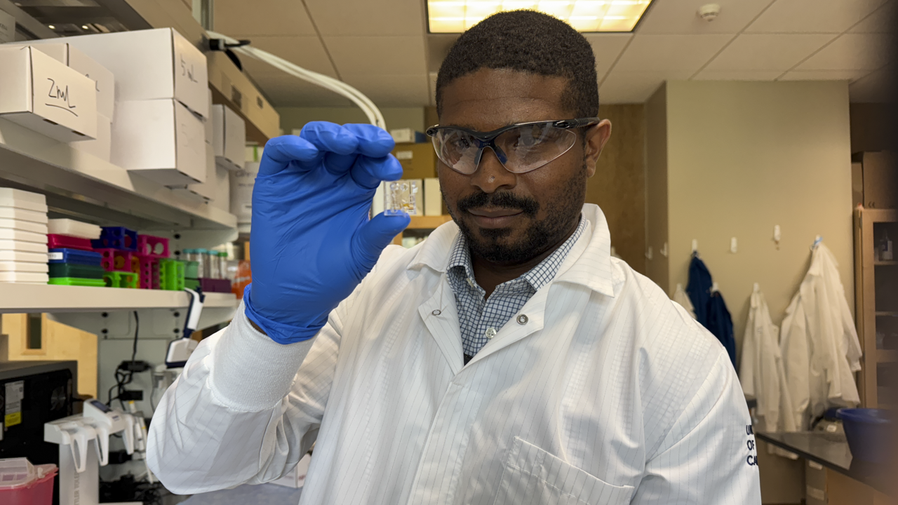 Man holding vial in science laboratory 